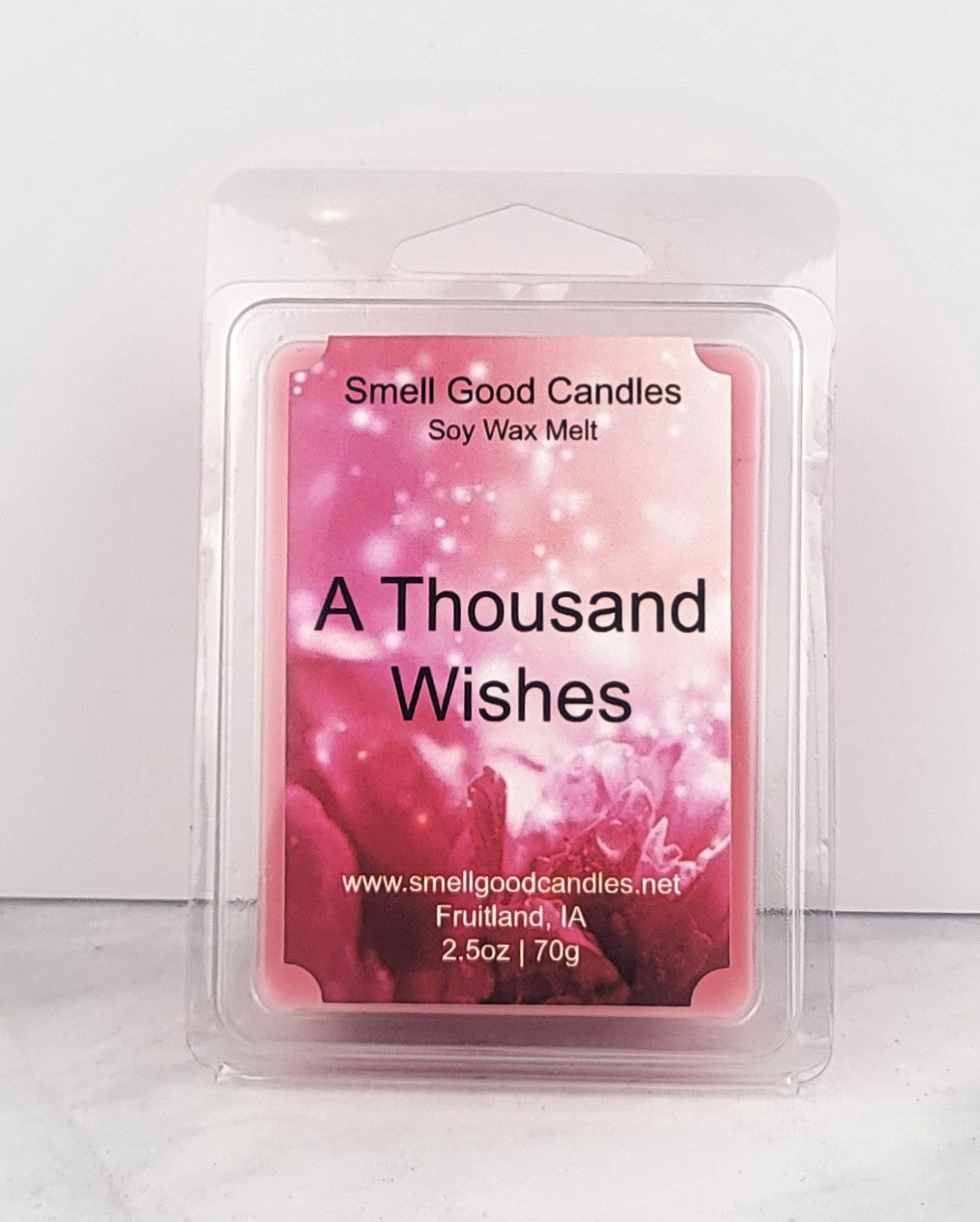 Pink wax melt inspired by BBW fragrance next to jasmine flowers and peony petals