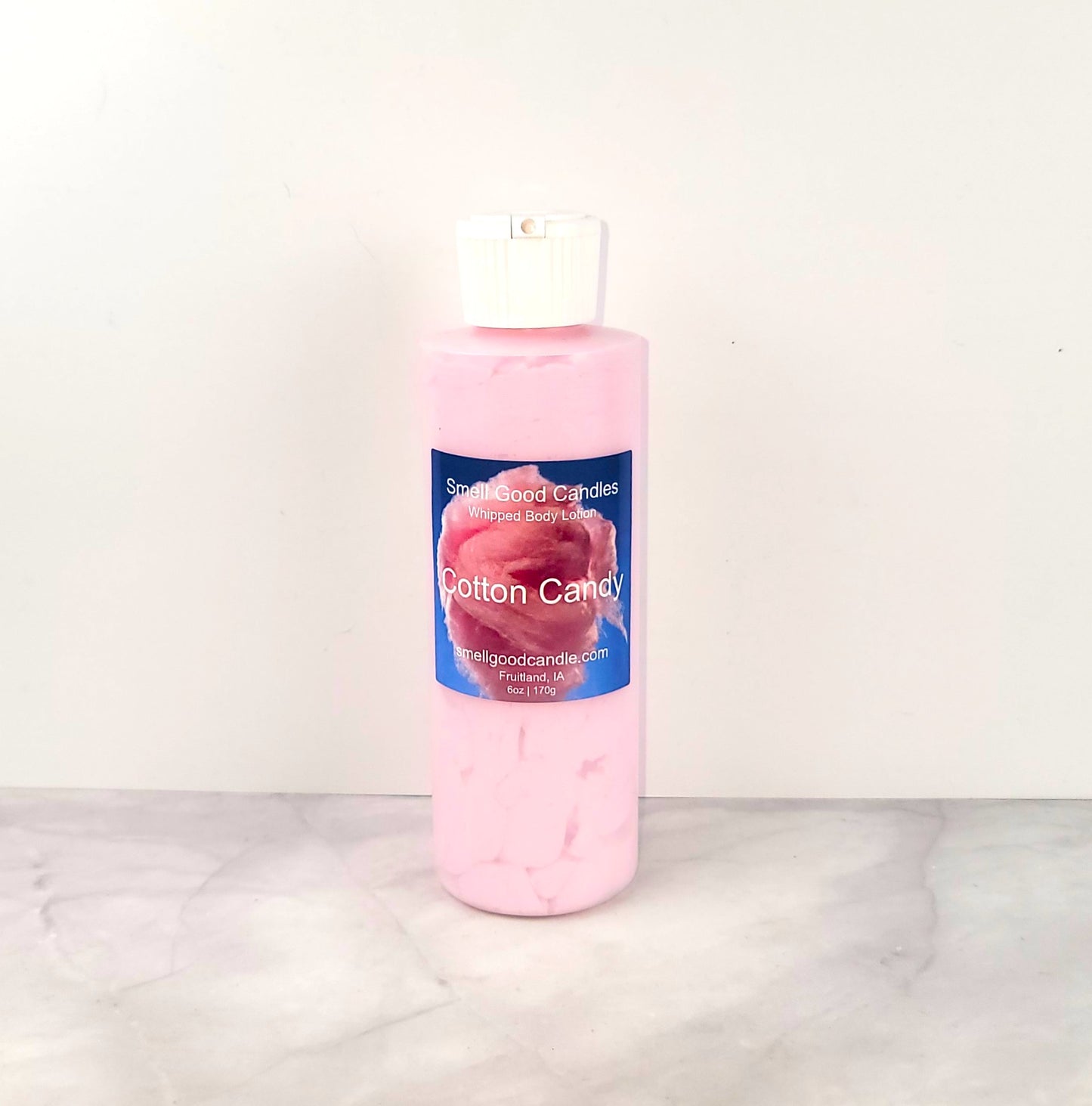 6oz Cotton Candy Whipped Body Lotion in a jar, featuring a sweet blend of strawberries, raspberries, cotton candy, and vanilla for soft, nourished skin.