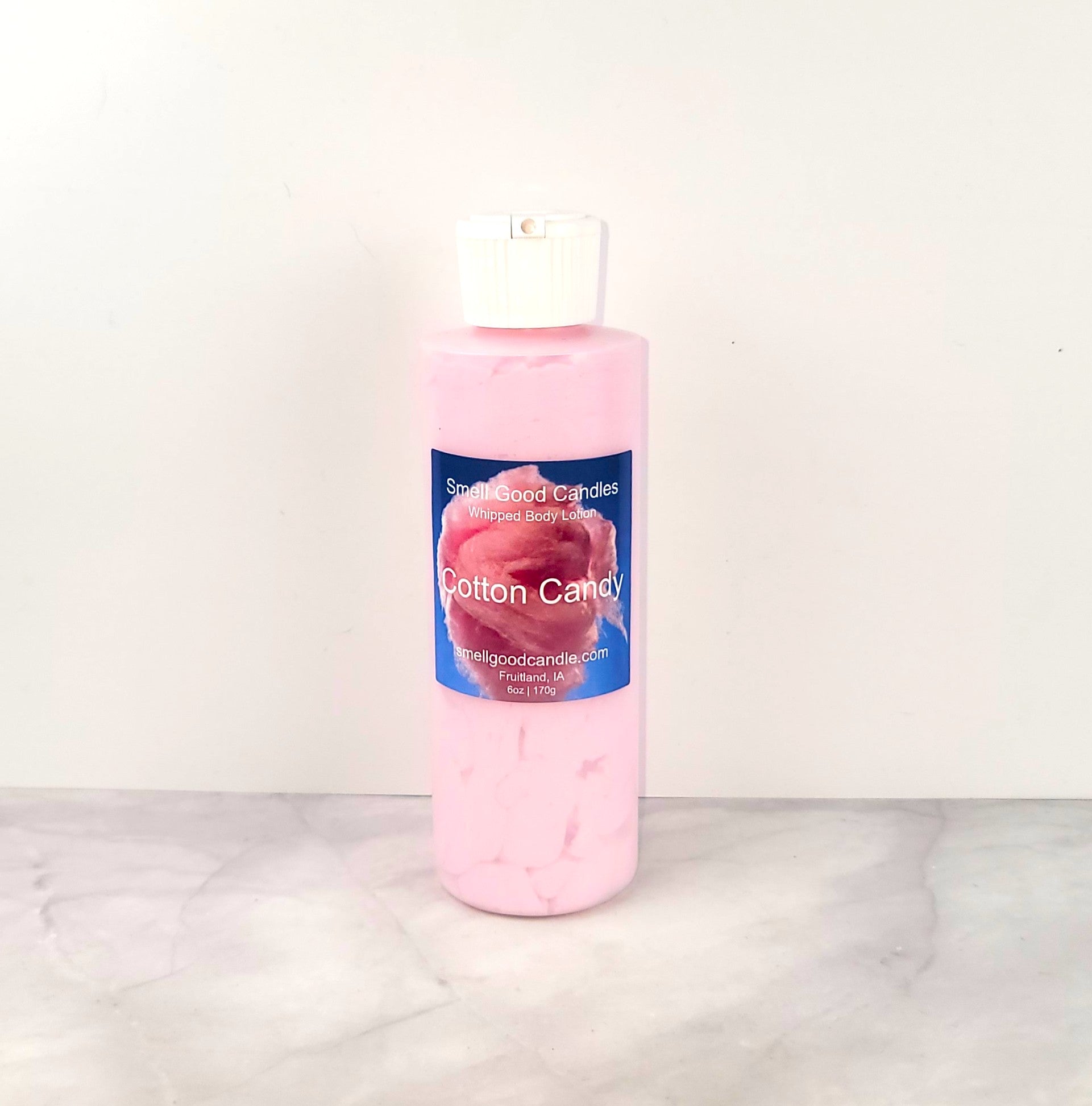 6oz Cotton Candy Whipped Body Lotion in a jar, featuring a sweet blend of strawberries, raspberries, cotton candy, and vanilla for soft, nourished skin.
