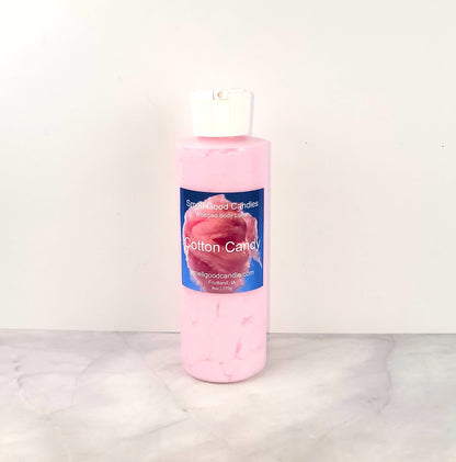 6oz Cotton Candy Whipped Body Lotion in a jar, featuring a sweet blend of strawberries, raspberries, cotton candy, and vanilla for soft, nourished skin.