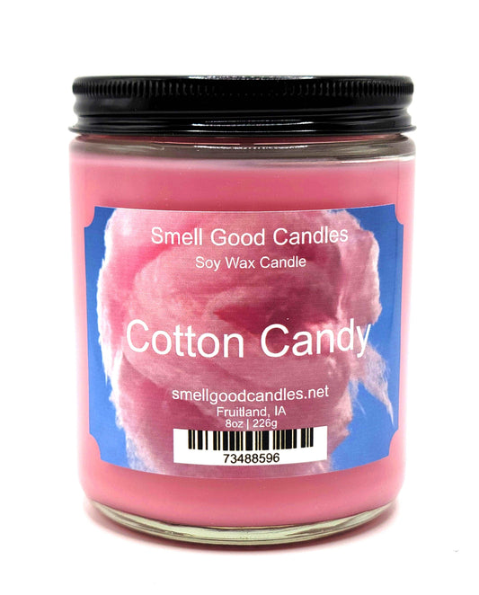 Pink cotton candy-scented candle in a stylish glass jar for home decor