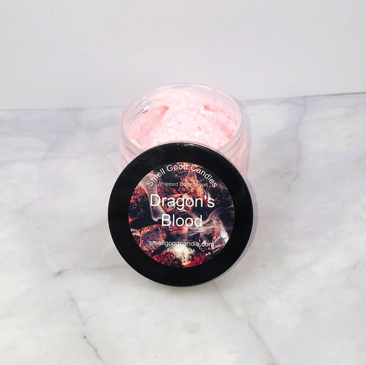 4oz Dragon’s Blood Whipped Body Lotion with citrusy orange, earthy cedar, and a spicy blend of patchouli and clove for deep hydration and a captivating scent.