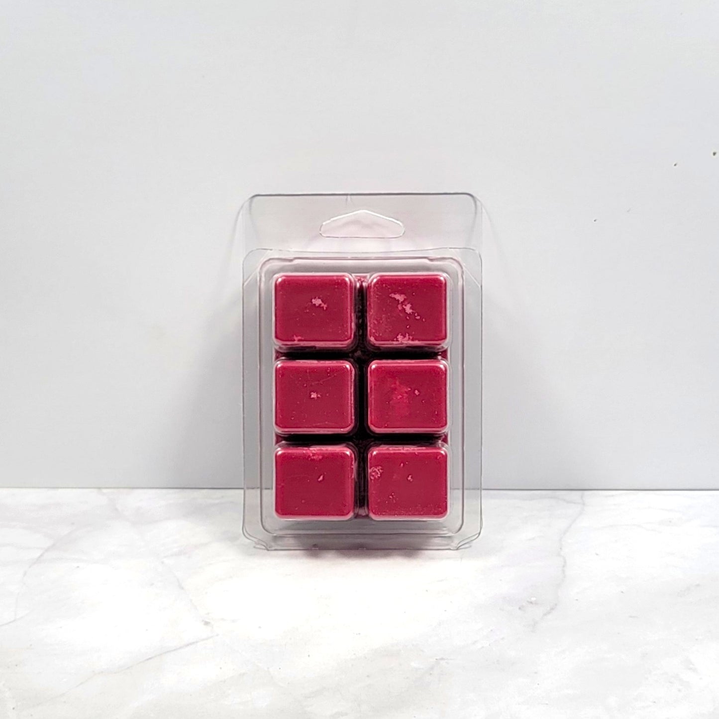 Bold earthy wax melt on dark wood with essential oils