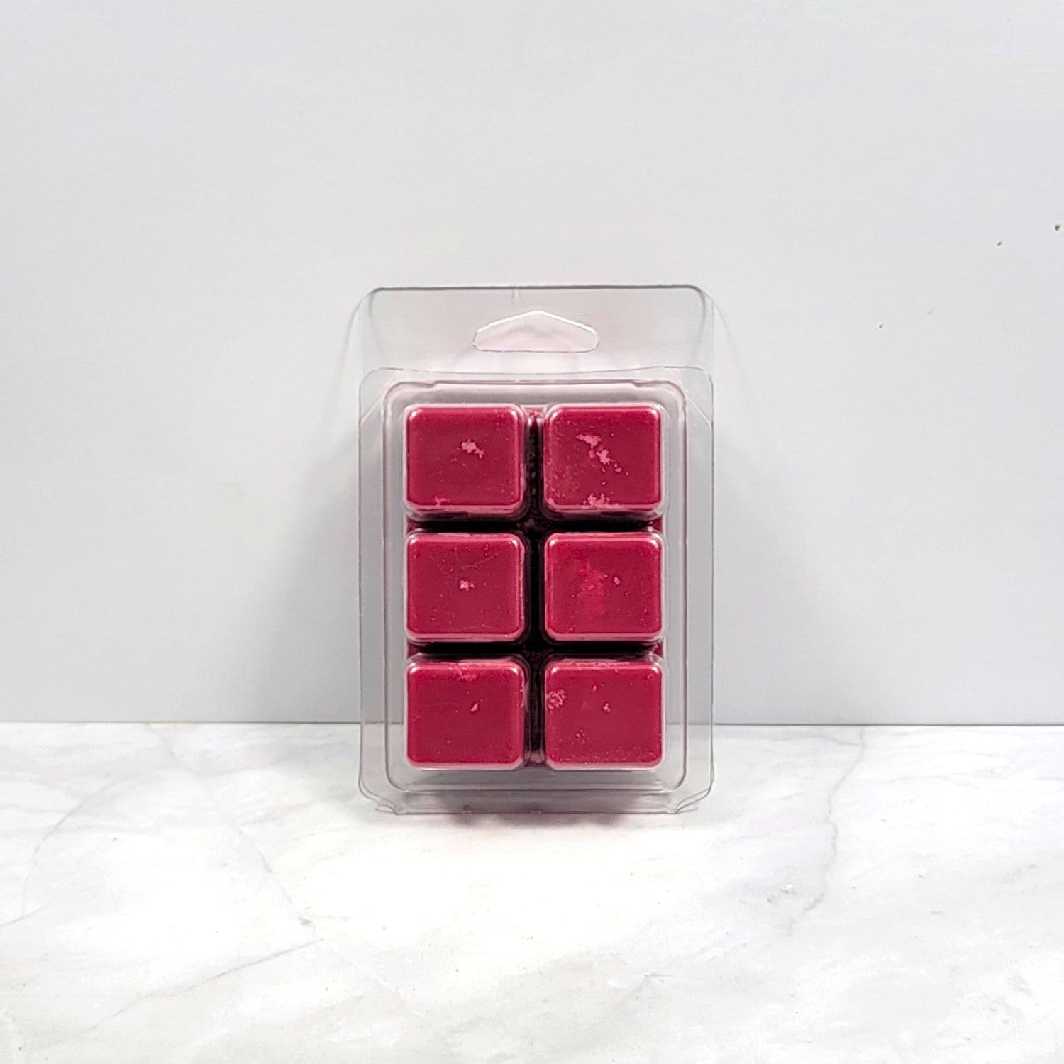Bold earthy wax melt on dark wood with essential oils