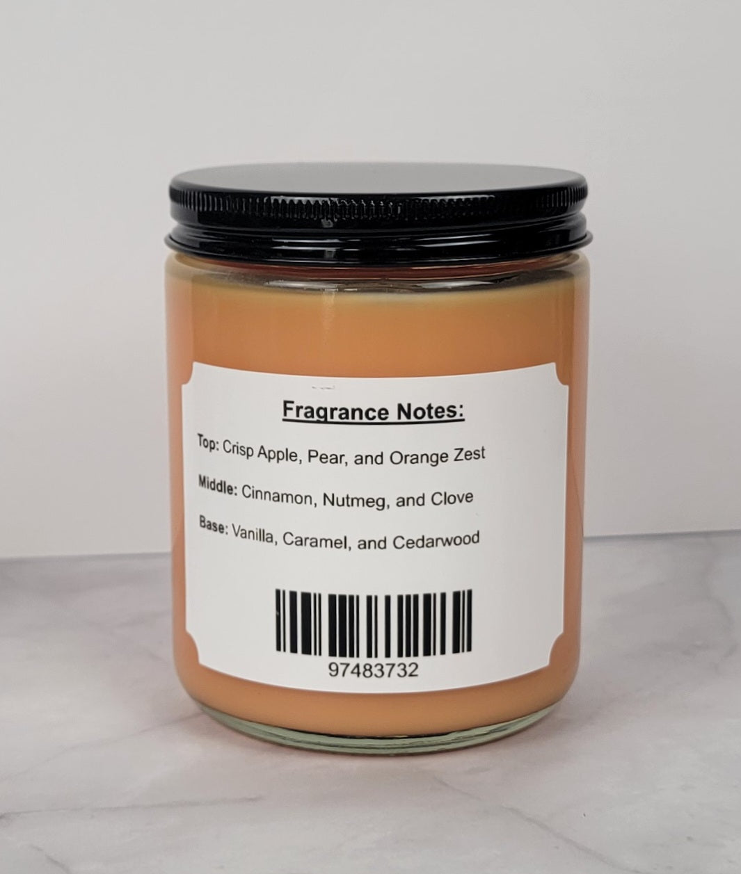 Hand-poured soy candle with cinnamon, apple, and vanilla scent.