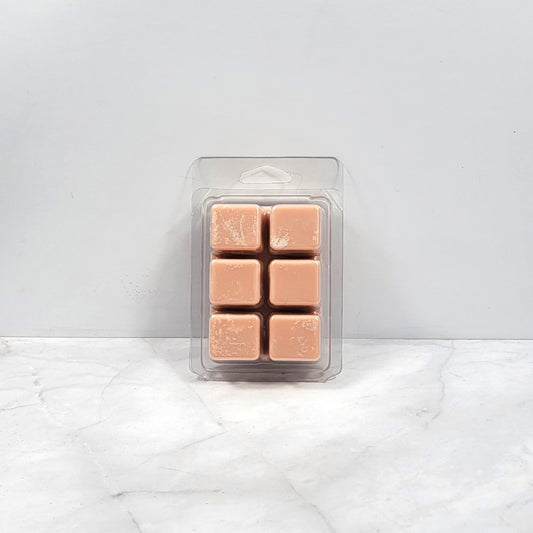 Soy wax melt with toasted marshmallows and smoky wood background